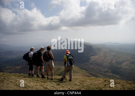 Walkers on the  Nantlle Ridge looking towards Moel Hebog in Snowdonia in North Wales Stock Photo