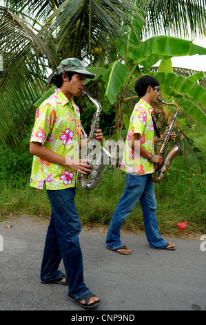 saxophone player during buddhist monk ordination ceremony,pong pang temple,bank of Mae Klong River,Amphawa,Samut Sakhon,thailand Stock Photo