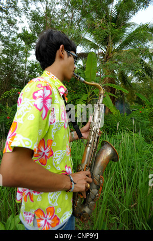 saxophone player during buddhist monk ordination ceremony,pong pang temple,bank of Mae Klong River,Amphawa,Samut Sakhon,thailand Stock Photo