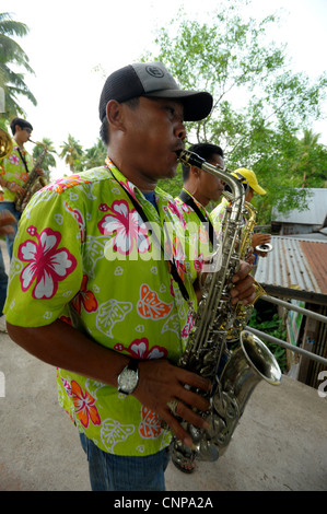 saxophone player during buddhist monk ordination ceremony,pong pang temple,bank of Mae Klong River,Amphawa,Samut Sakhon,thailand Stock Photo