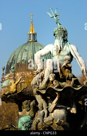 Berlin, Germany. Neptunbrunnen / Neptune Fountain (Reinhold Begas; 1886) in Rathausvorplatz. Berliner Dom / Cathedral behind Stock Photo