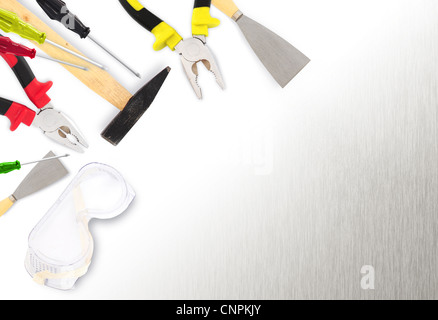 Different tools - hammer, pliers, screwdrivers,spatula, paint roller on metal surface with copy space Stock Photo