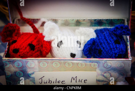 Red, white and blue, knitted mice in a box for sale in a Queen's jubilee craft fair in Warrington market, Cheshire Stock Photo