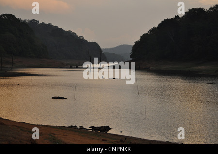 Sun sets over the reservoir at Mullaperiyar dam, at thekkady wild life sanctuary, Kerala, India Stock Photo