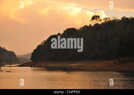 Sun sets over the reservoir at Mullaperiyar dam, at thekkady wild life sanctuary, Kerala, India Stock Photo