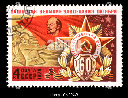 Postage stamp from the Soviet Union (USSR) depicting the Defenders of Moscow monument and a flag with Lenin on it. Stock Photo