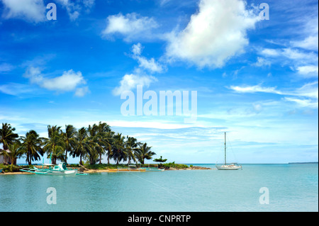 Tropical landscape with traditional Philippines boats and yacht on Calicoan island, Philippines Stock Photo