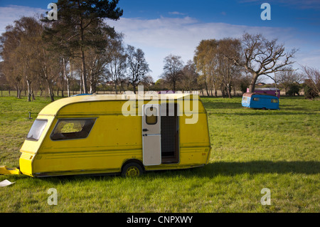 Brightly painted touring and static caravans on abandoned site called Broadsview caravans Stock Photo