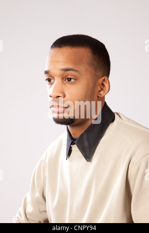 Handsome young black man with pensive expression looking left Stock Photo
