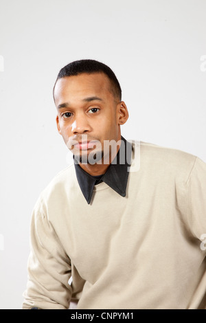 Handsome young black man with pensive expression looking at the camera Stock Photo