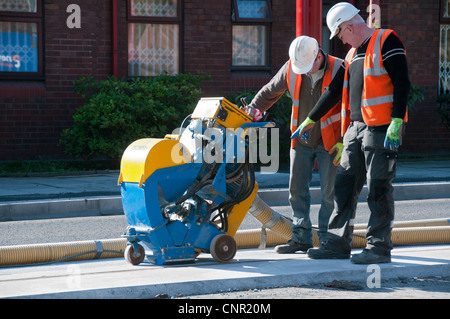 Industrial vacuum cleaner in use on new tram track, Metrolink Ashton line at Droylsden, Tameside, Manchester, England, UK Stock Photo