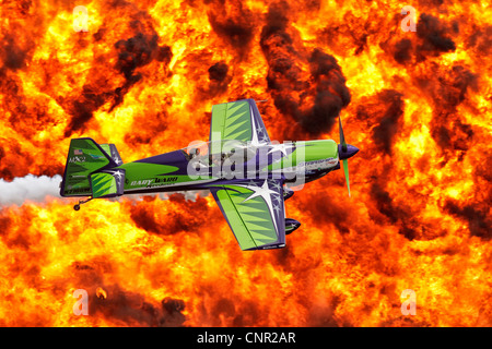 Gary Ward flies his airshows MX2 low against a firewall back drop Stock Photo