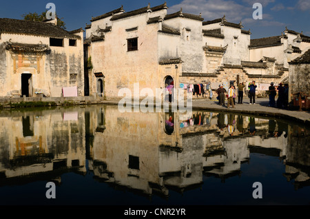 Ancient white buildings reflected in the blue still Half moon pond in Hongcun village Peoples Republic of China Stock Photo