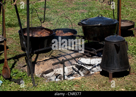 camping cooking on campfire with old iron pots Stock Photo - Alamy