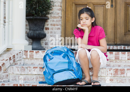 Girl with Backpack Sitting on Steps Stock Photo