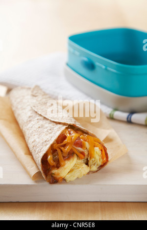 Close view of a scrambled egg burrito meal on a yellow plate Stock ...
