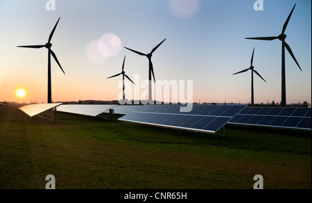 Wind turbines and solar panels in field Stock Photo
