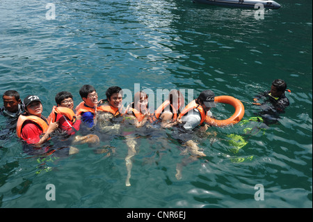 chain of swimmers Swimming into Morakot cave , the island of koh mook ...