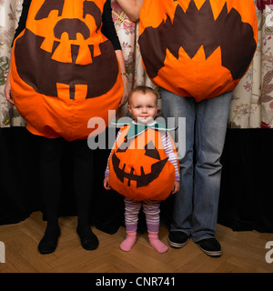 Family dressed as pumpkins for Halloween Stock Photo