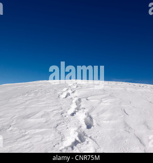 Footprints on snowy hill