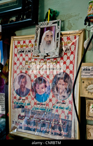 The old lady of Awarta, who sleeps only with her photos of martyrs., The pictures of the martyrs are covering the four walls. Stock Photo