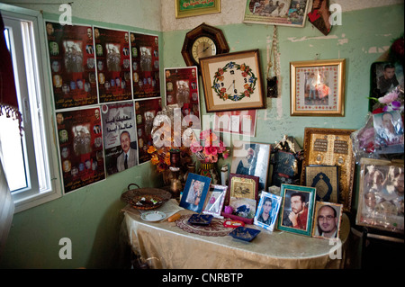 The old lady of Awarta, who sleeps only with her photos of martyrs., The pictures of the martyrs are covering the four walls. Stock Photo