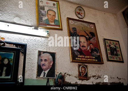 The old lady of Awarta, who sleeps only with her photos of martyrs., The pictures of the martyrs are covering the four walls. Stock Photo