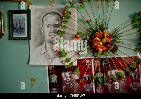 The old lady of Awarta, who sleeps only with her photos of martyrs., The pictures of the martyrs are covering the four walls. Stock Photo