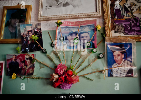 The old lady of Awarta, who sleeps only with her photos of martyrs., The pictures of the martyrs are covering the four walls. Stock Photo