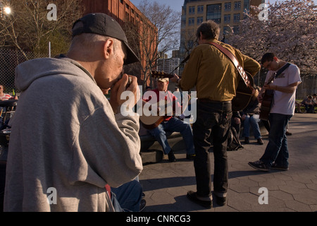 Musicians playing together at Washington Square Park in New York City's Greenwich Village. Stock Photo