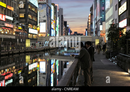 businessmen at Dotombori river at sunset, Osaka, Japan Stock Photo