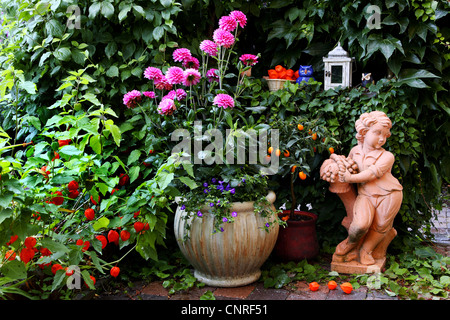 garden with garden decorations in summer Stock Photo