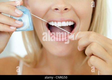 Woman using dental floss, cropped Stock Photo