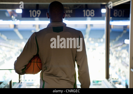 Man looking down at stadium, rear view Stock Photo