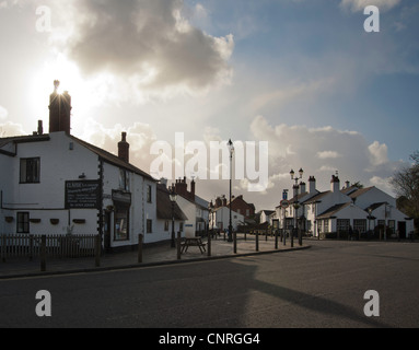 Traditional English village street with pub. Stock Photo