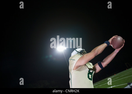 Football player catching football Stock Photo