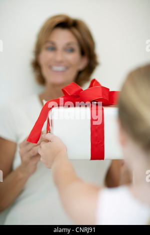 Girl giving mother gift Stock Photo