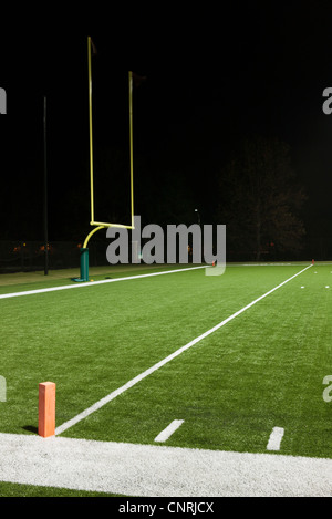 Goal post on empty football field Stock Photo