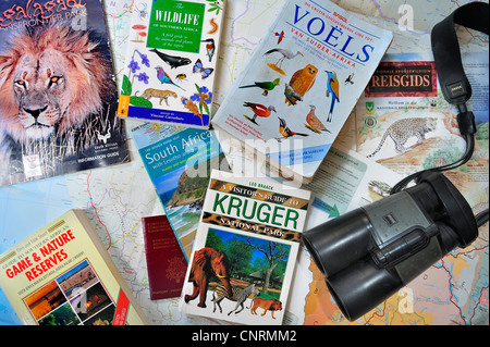 Binoculars, travel guides, guidebooks, African wildlife determination books and South African map for planning safari holiday Stock Photo