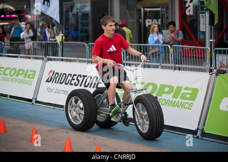 Bridgestone displays their Ecopia automobile tires on a human-powered tricycle at an Earth Day event in Times Square in New York Stock Photo