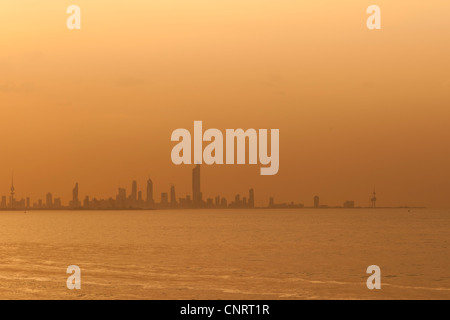 Kuwait City skyline at sunset with many major landmarks identifiable Stock Photo
