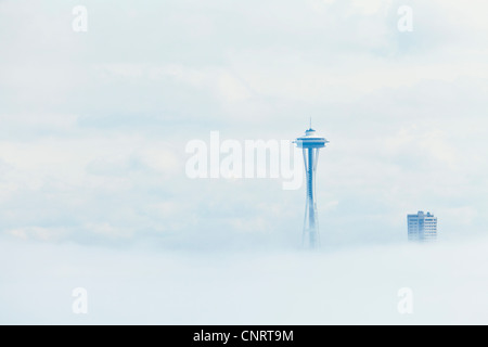 A fog bank obscures downtown Seattle and the Space Needle sticks up through the fog, Washington USA Stock Photo