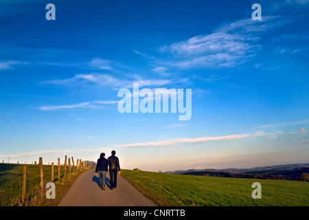 couple walking on path in rural environment, Bergisches Land, Germany, North Rhine-Westphalia, Breckerfeld Stock Photo