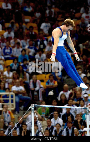 GYMNASTICS Paul Hamm (USA) competing on the high bar during the men's individual all around finals, where he won the gold Stock Photo