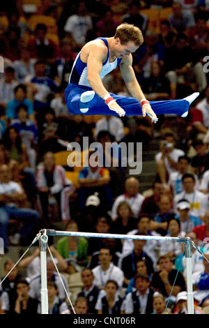 GYMNASTICS Paul Hamm (USA) competing on the high bar during the men's individual all around finals, where he won the gold Stock Photo