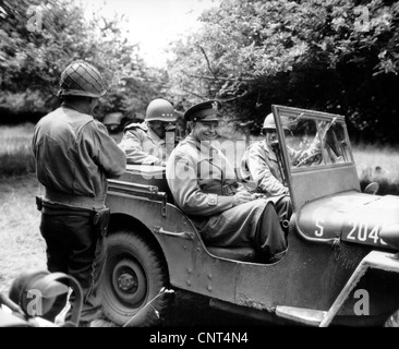 Vintage World War II photo of General Dwight D. Eisenhower sitting in a jeep talking with other officers. Stock Photo