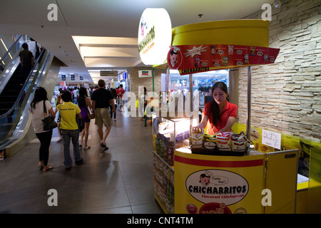 Woman working at a food counter in SM City Cebu shopping mall. Cebu City, Visayas, Philippines. Stock Photo