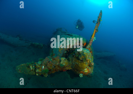 Diver explores the wreck of a Mitsubishi Zero fighter plane, Kimbe Bay, Papua New Guinea. Stock Photo