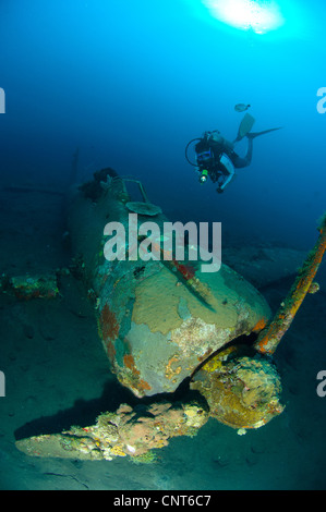 Diver explores the wreck of a Mitsubishi Zero fighter plane, Kimbe Bay, Papua New Guinea. Stock Photo