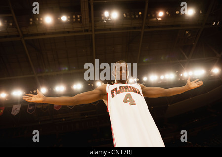 Basketball player standing with arms out, low angle view Stock Photo